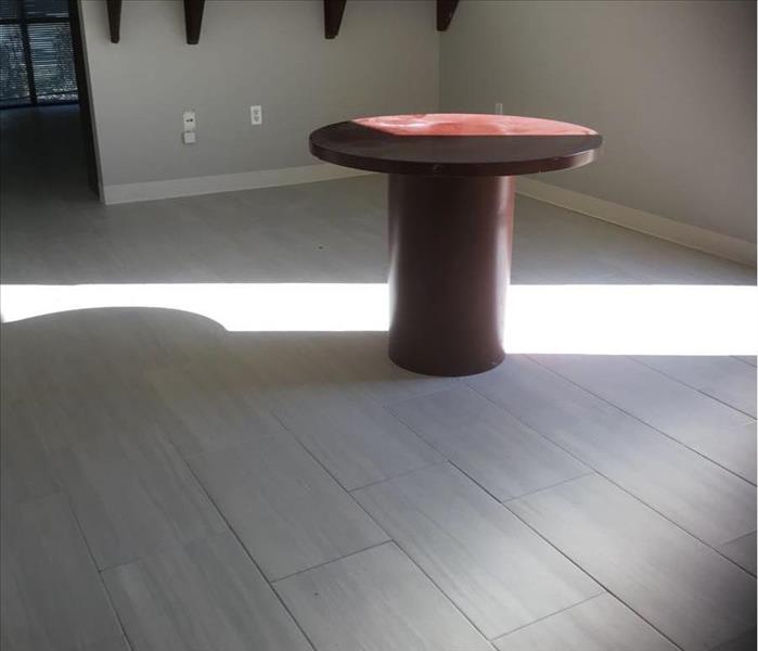 Table in a room with windows along one side