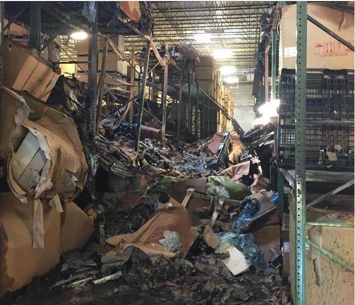 Warehouse or Storage area of business with piles of burned debris/contents