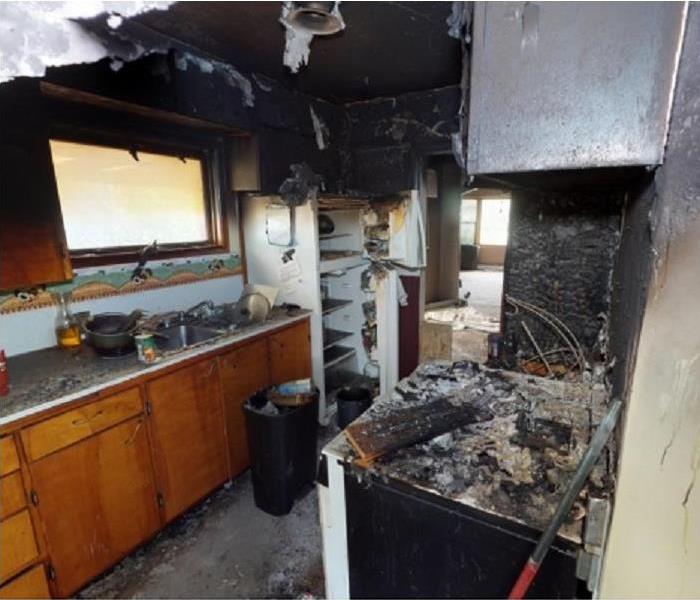 Kitchen with alot of fire damage, burned cabinets