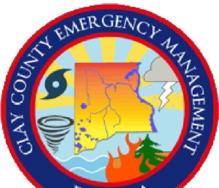 Round emblem with Clay County Emergency written in outer circle