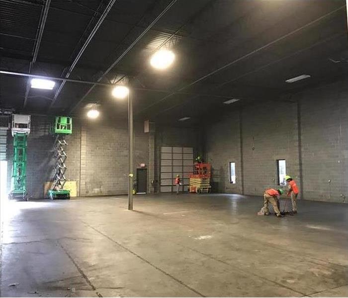 Warehouse or Storage area empty with a forklift and man cleaning